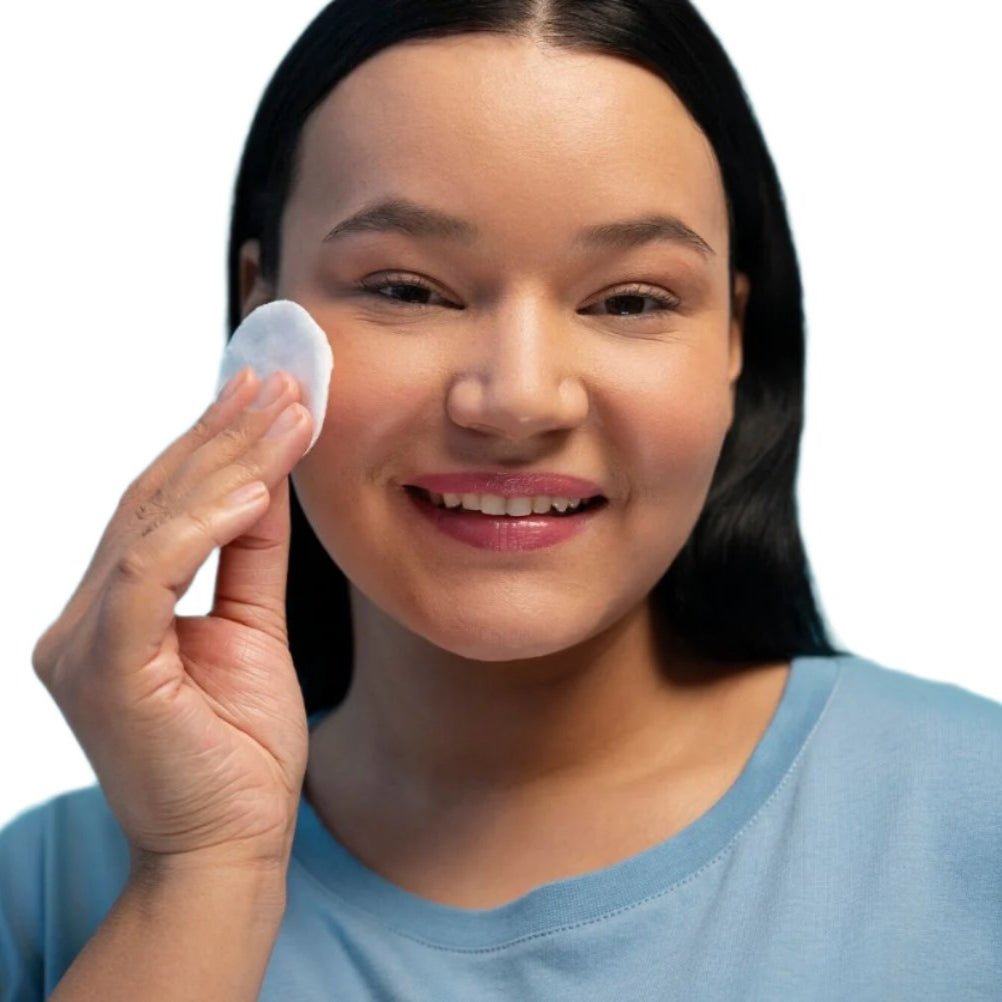 Model showing off glowing, even-toned skin after using Brighten: A Toner.