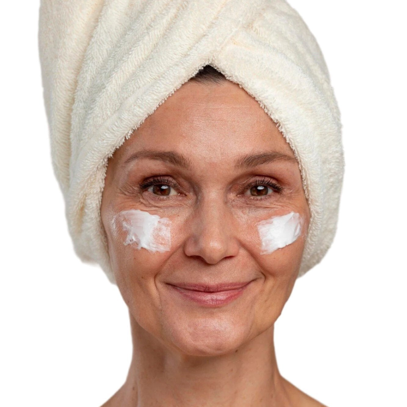 White woman in white head towel with cream on cheeks. Best anti-aging face cream. Dermal Essentials Medical Grade Skincare.