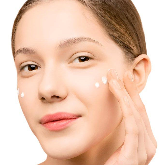 White woman light brown hair brown eyes applying face serum . Best anti-aging face serum with hyaluronic acid.Dermal Essentials Medical Grade Skincare.