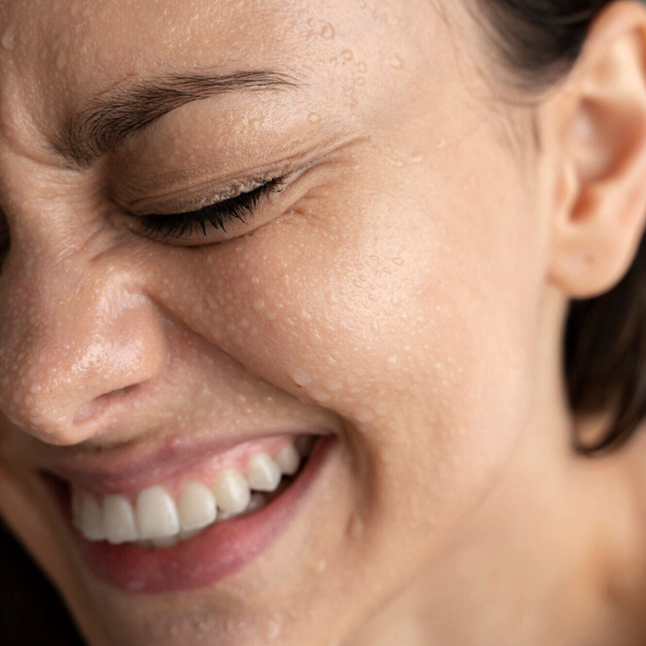 white woman with Spray on face to hydrate and calm irritated skin anytime