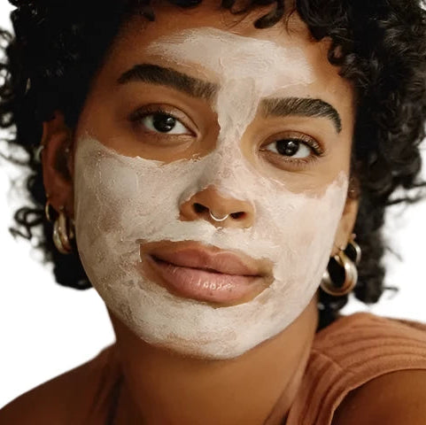 Black woman black hair gold jewelry with best pumpkin enzyme mask on face. Dermal Essentials Medical Grade Skincare.