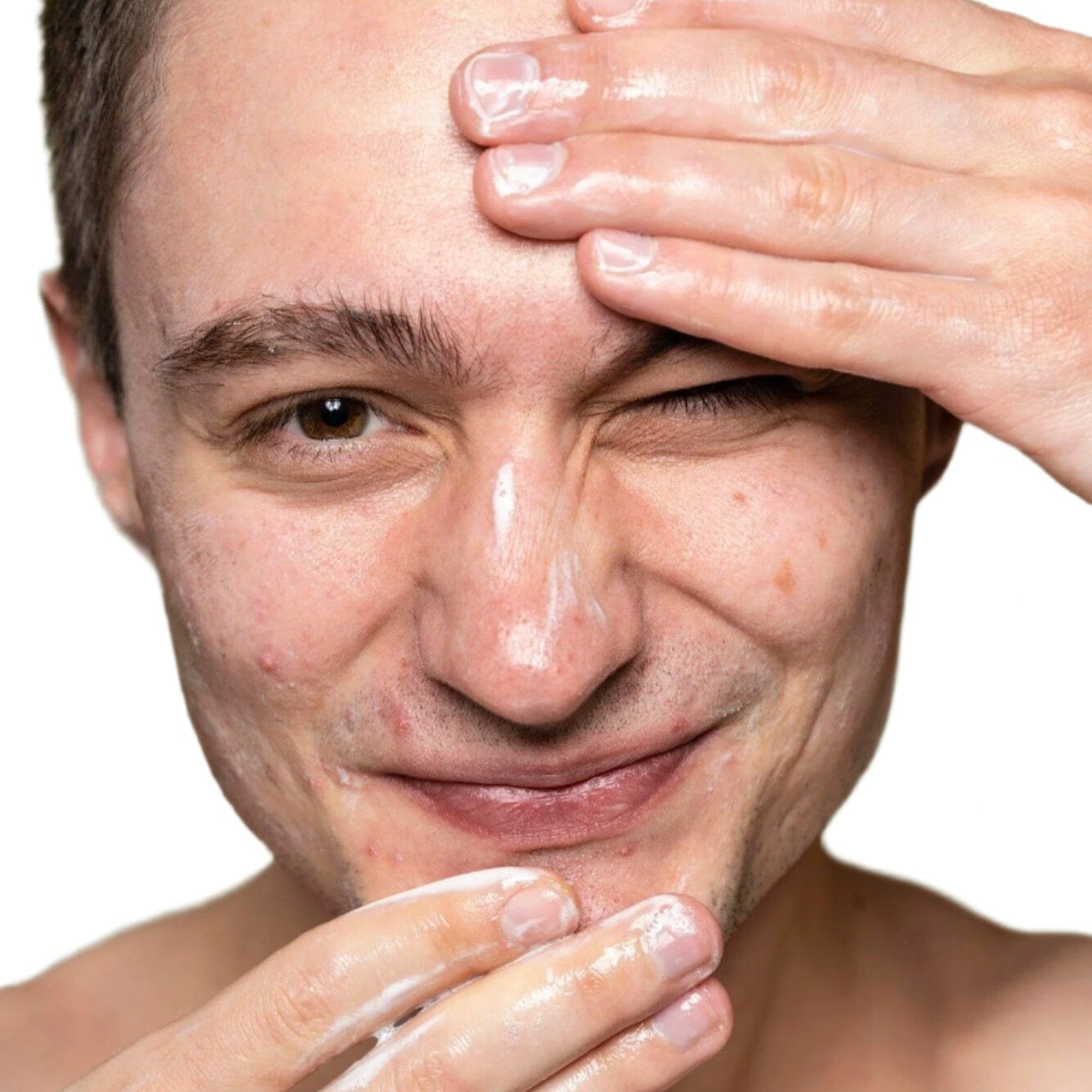 white young man brown hair applying facial cleanser dermal essentials medical grade skincare
