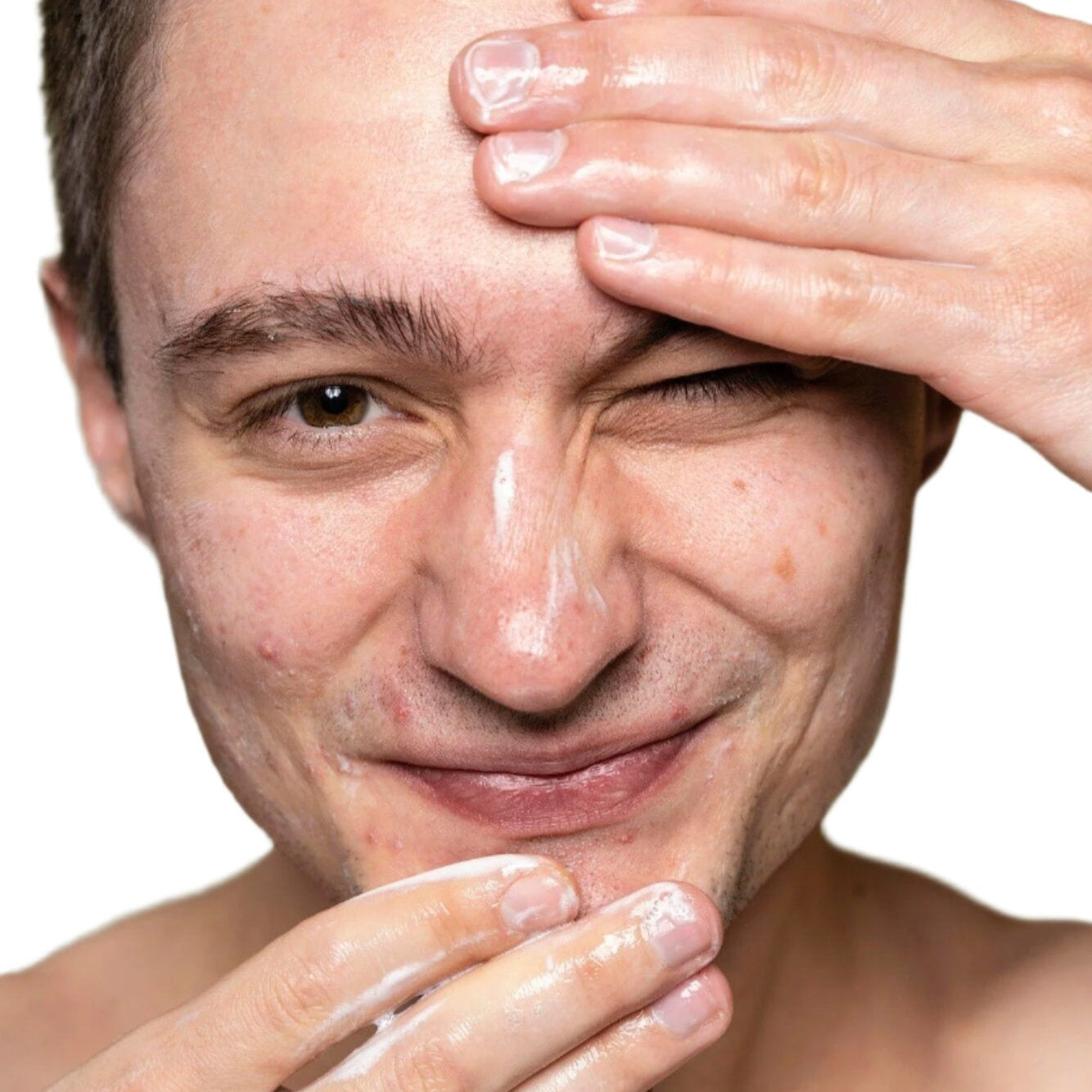 white young man brown hair applying facial cleanser dermal essentials medical grade skincare