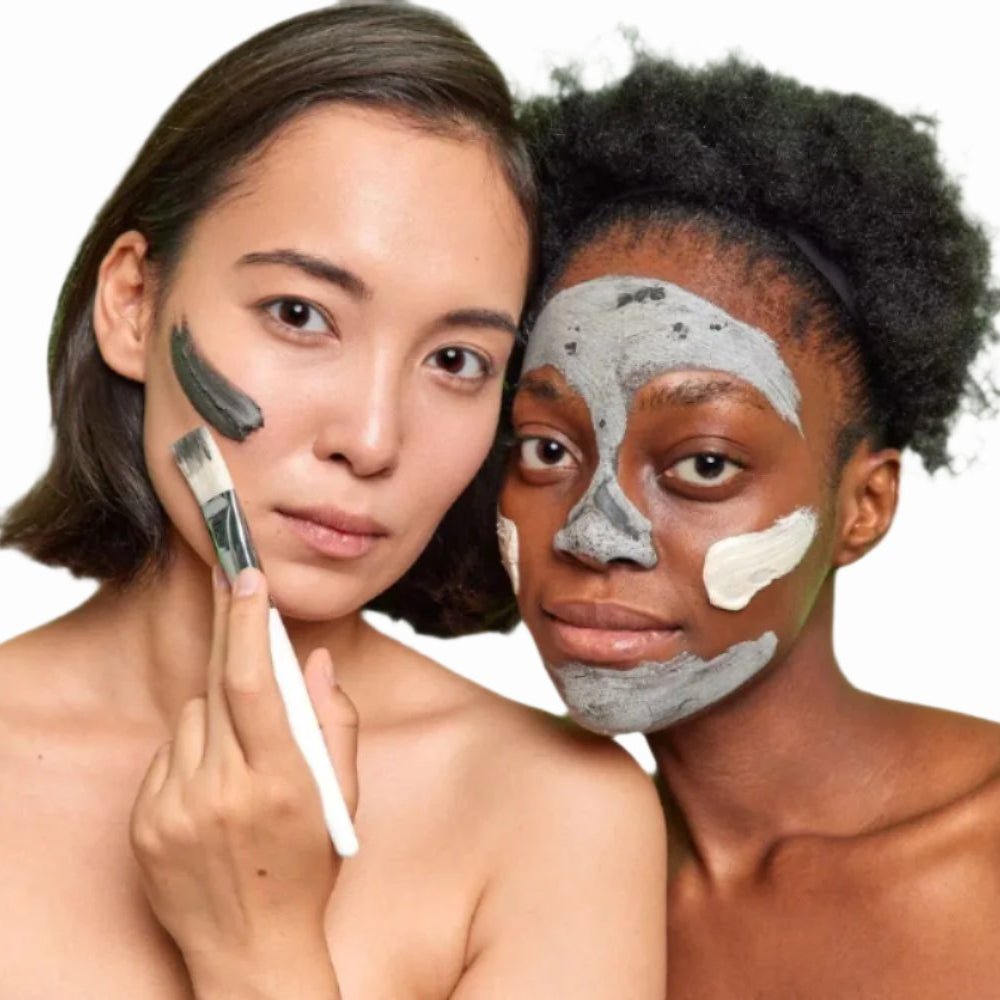 asian woman black woman applying sulphur acne facial mask with white brush dermal essentials clinical skincare