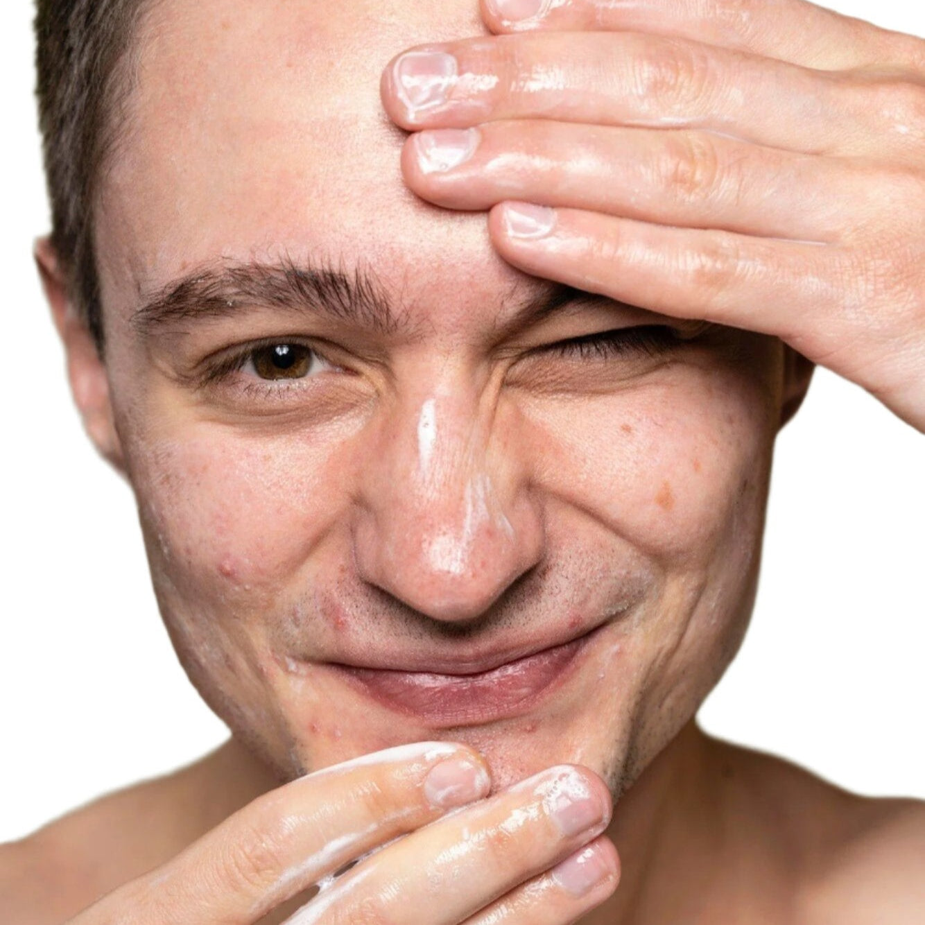 white young man brown hair applying facial cleanser dermal essentials medical grade skincare