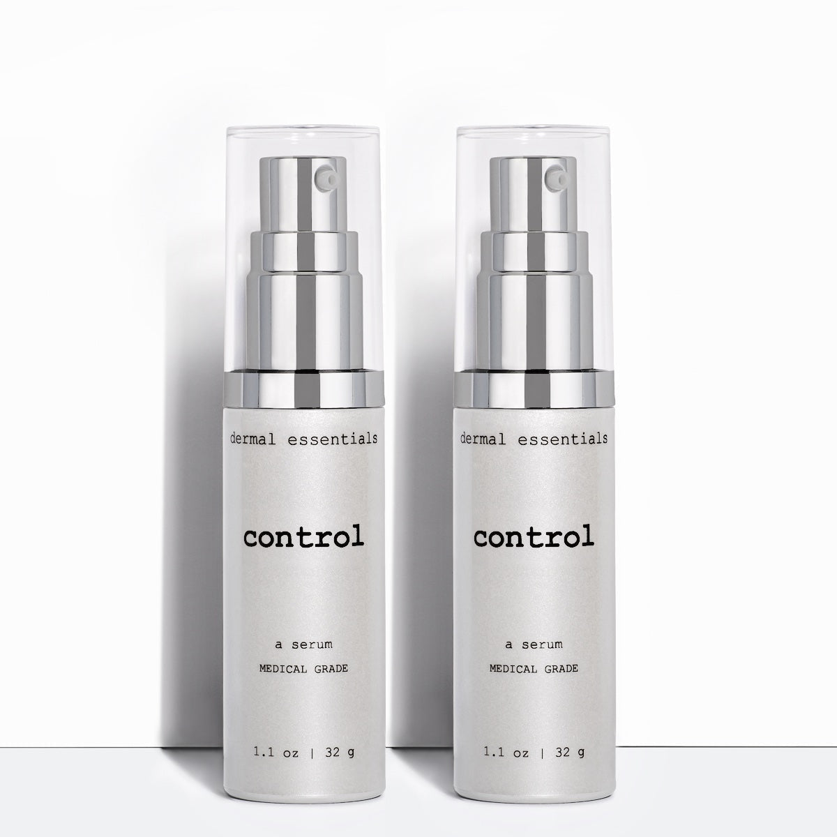Two Silver cylinder plastic bottles black letters silver plastic pump clear plastic lid 1.1 fl.oz. Control acne benzoyl peroxide glycolic acid acne skincare serum Dermal Essentials Medical Grade Skincare