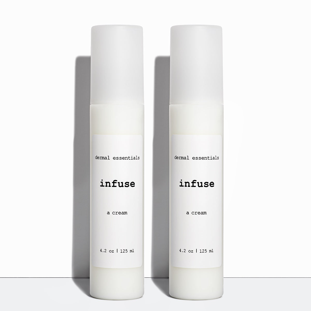 Two white plastic cylinder bottles white label black letters white plastic pump 4.2 oz. best anti-aging face cream peptide Hyaluronic acid face cream dermal essentials medical grade skincare