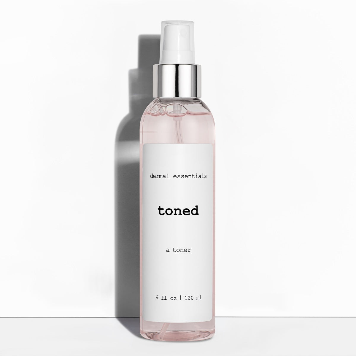 Clear cylinder plastic bottle white label black letters white spray nozzle clear plastic lid 6 fl. oz. Best anti-aging facial toner. Dermal Essentials Medical Grade Skincare.