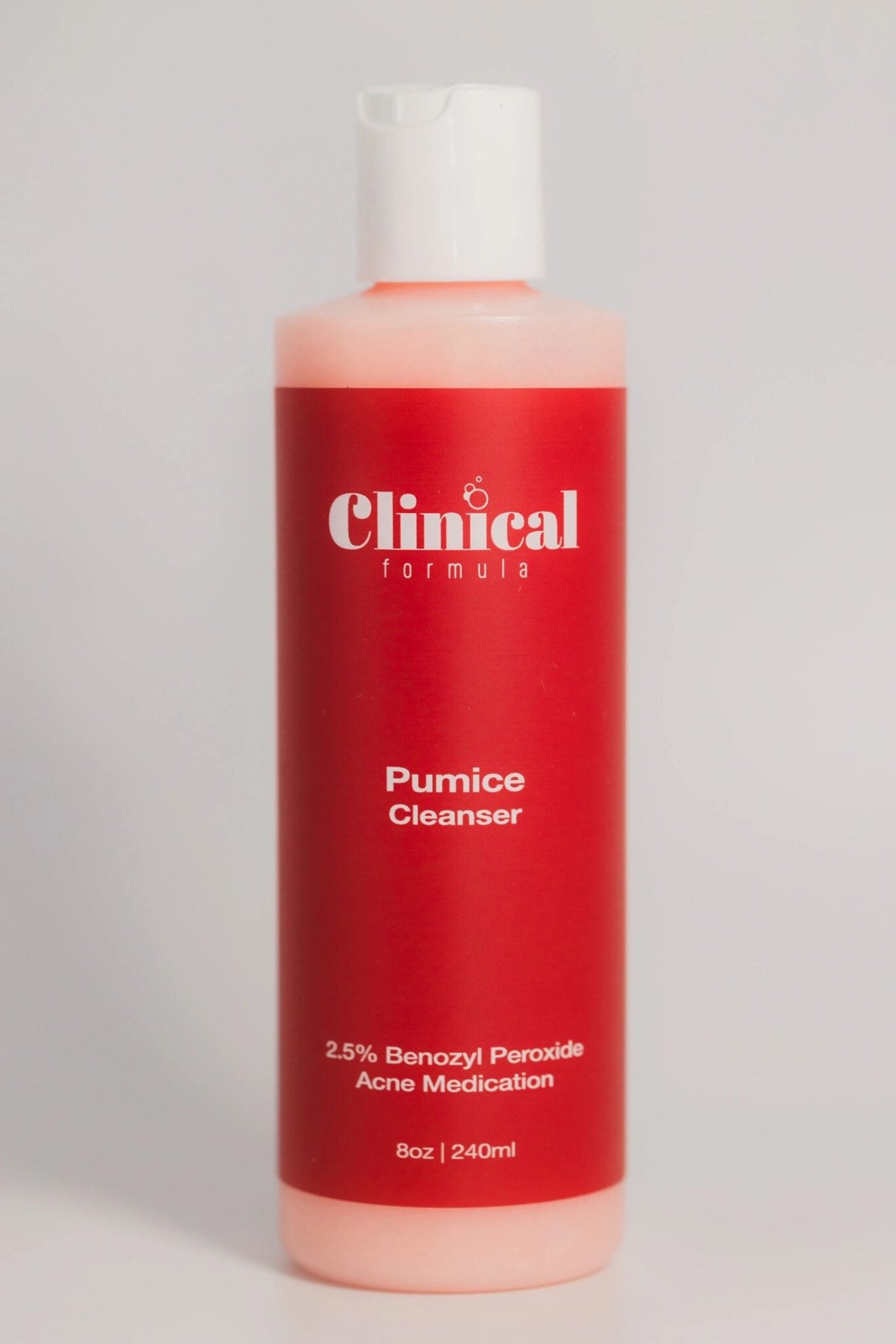 clear plastic 8oz. bottle with red label & pink benzoyl peroxide acne cleanser