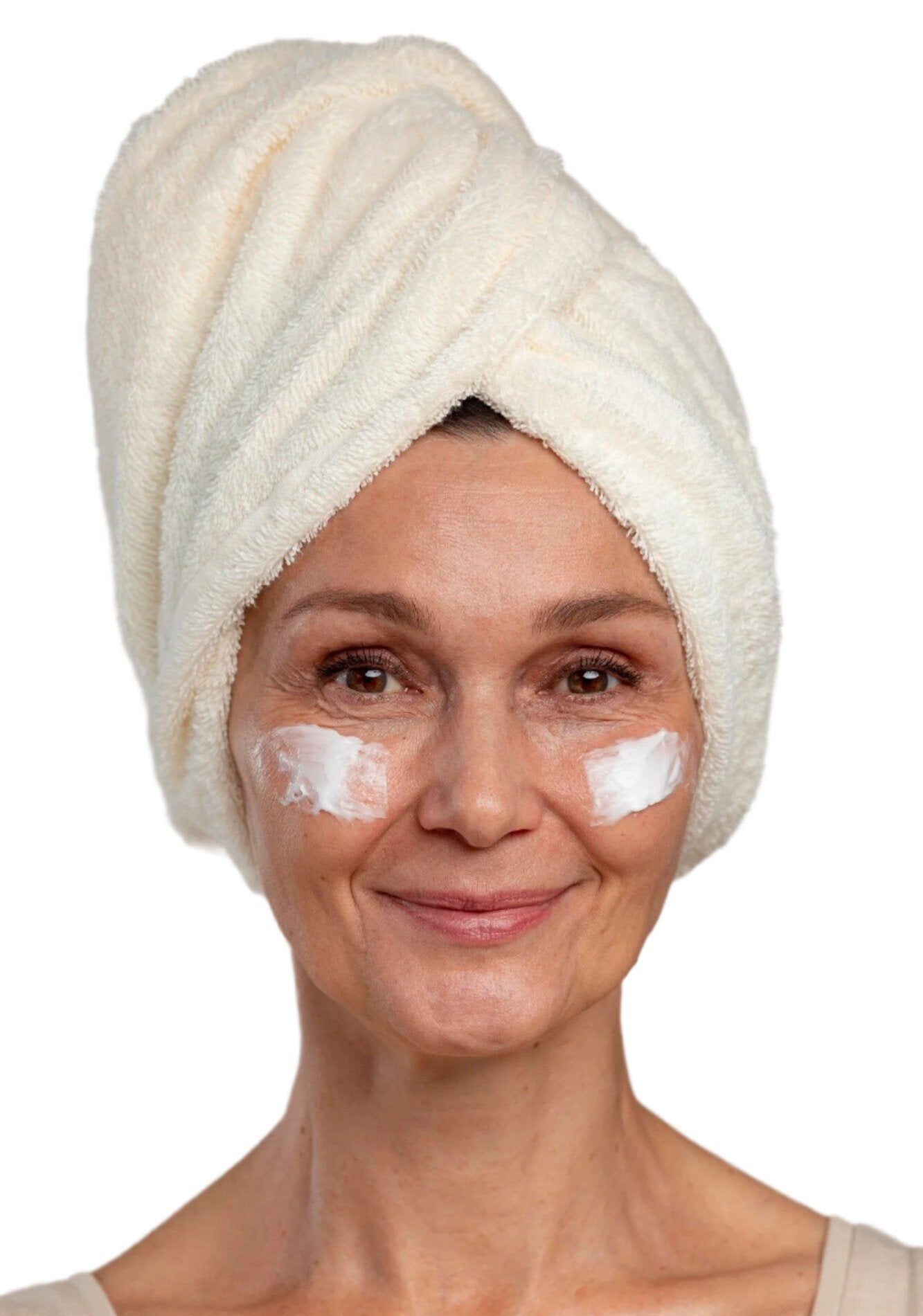 White woman in white head towel with face cream on cheeks. Best anti-aging face cream. Dermal Essentials Medical Grade Skincare.