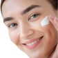 young-white-woman-applying-face-cream