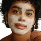 Black woman black hair gold jewelry with best pumpkin enzyme mask on face. Dermal Essentials Medical Grade Skincare.