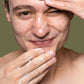 A person applying Clarify: A Cleanser to the face