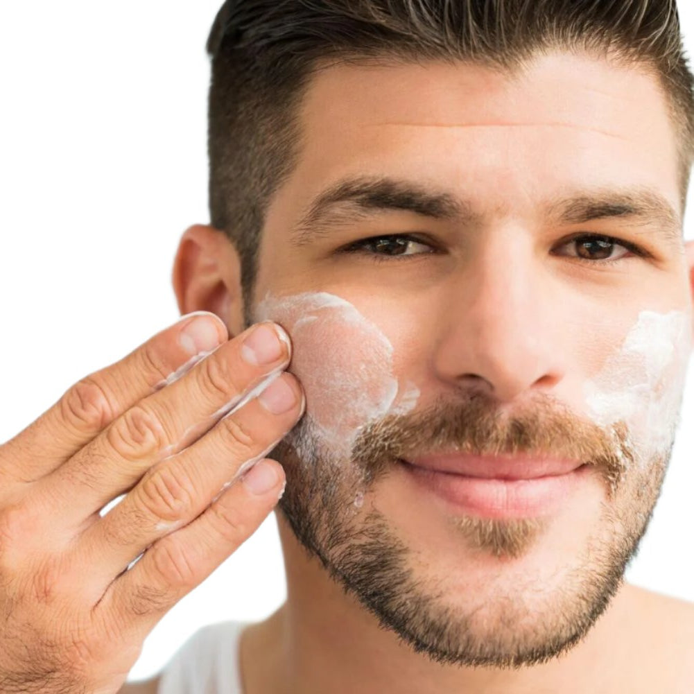 White man brown hair with beard applying best oil free moisturizer to face. Dermal Essentials medical grade skincare.