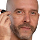 White bald man with beard using black dropper to apply best skin plumping serum. Dermal Essentials Medical Grade Skincare.