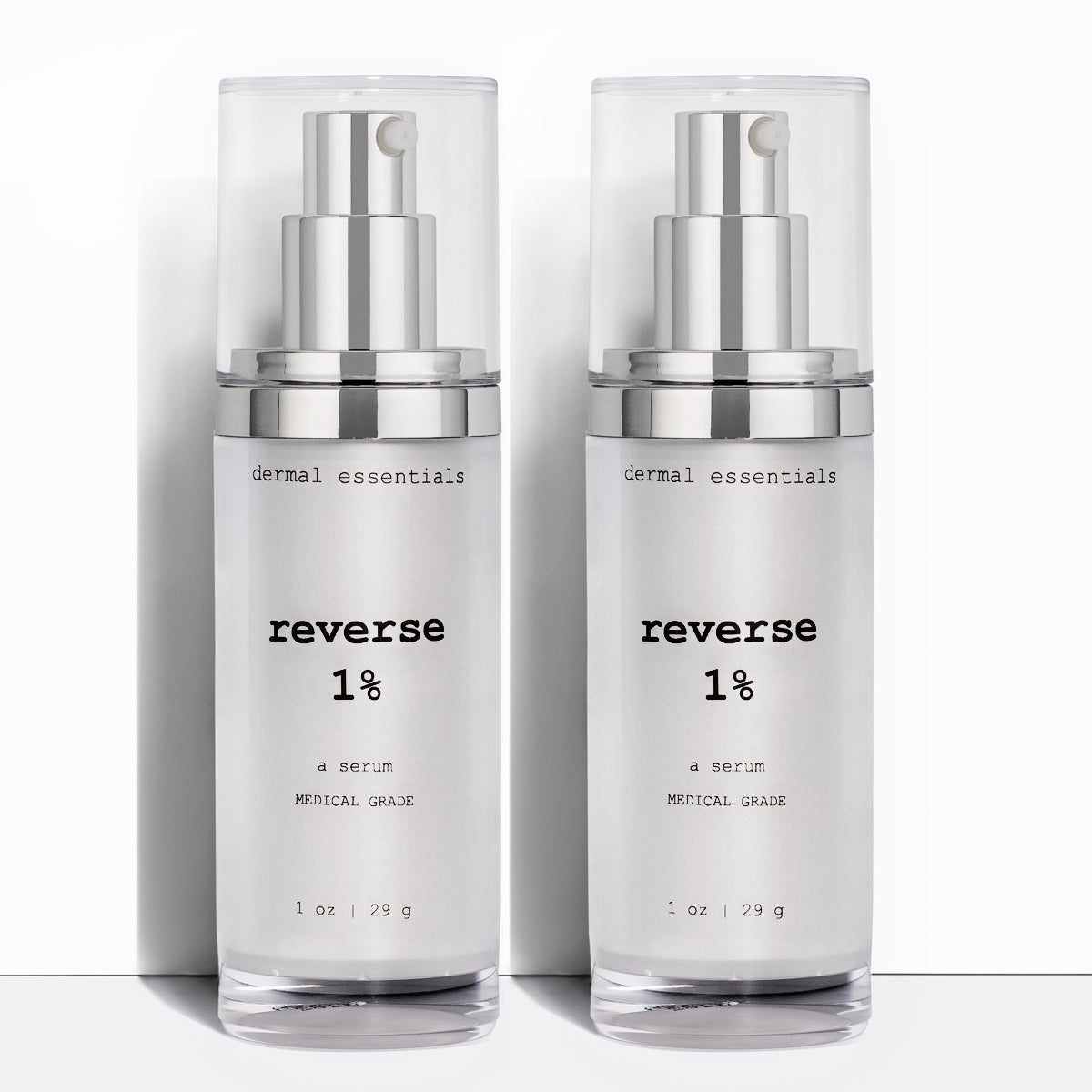 Two Silver cylinder plastic bottles black letters silver plastic pump clear plastic cap 1 oz. Best anti-aging 1% retinol and vitamin c facial serum. Dermal Essentials Medical Grade Skincare.  