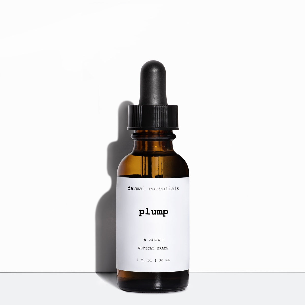 Glass amber cylinder bottle white label black letters black eye dropper 1 fl. oz. Best skin plumping serum.Dermal Essentials Medical Grade Skincare.