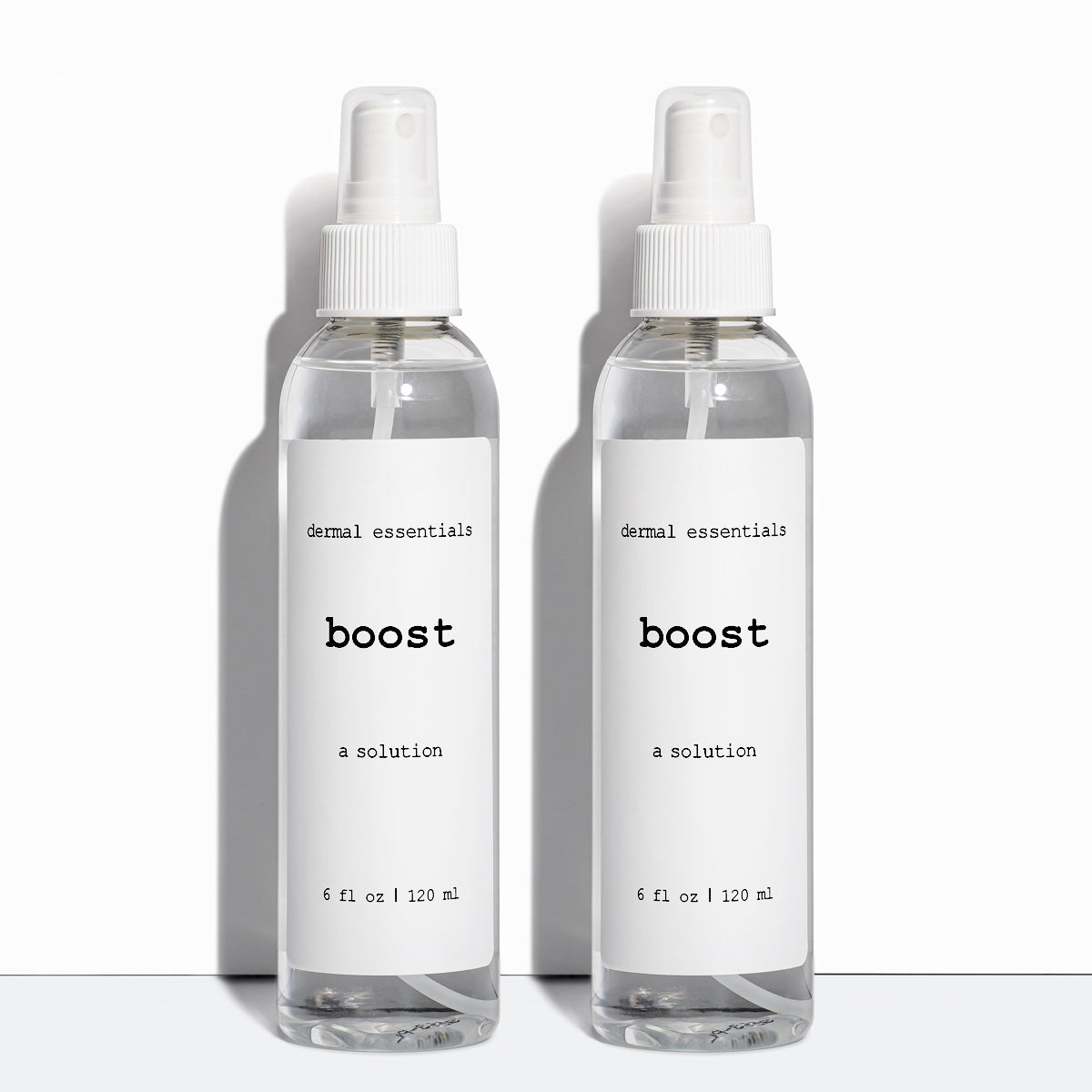 Two  Clear cylinder plastic bottles white label black letters white spray nozzle clear plastic lid 6 fl. oz. Boost calming facial spray Dermal Essentials Medical Grade Skincare  