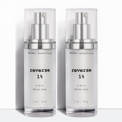 Two Silver cylinder plastic bottles black letters silver plastic pump clear plastic cap 1 oz. Best anti-aging 1% retinol and vitamin C face serum. Dermal Essentials Medical Grade Skincare.  